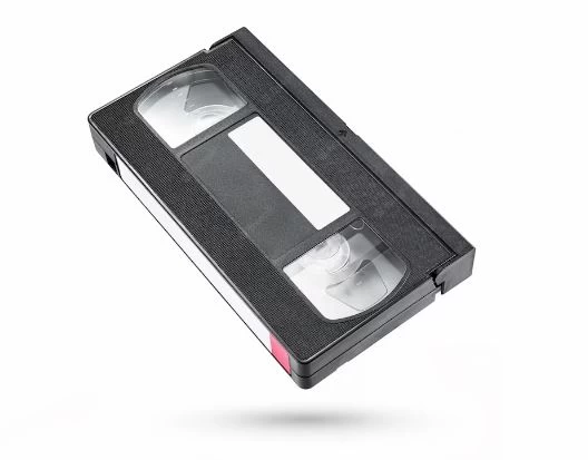 A black vhs video tape cassette isolated on white background.