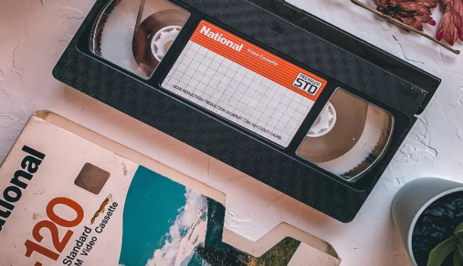 Black VHS Tape with its cover on a white table.